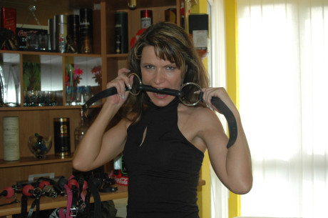Caucasian female tries on a few ball gags while fully clothed - #105699