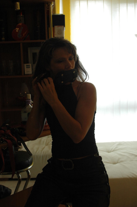 Caucasian female tries on a few ball gags while fully clothed - #105703