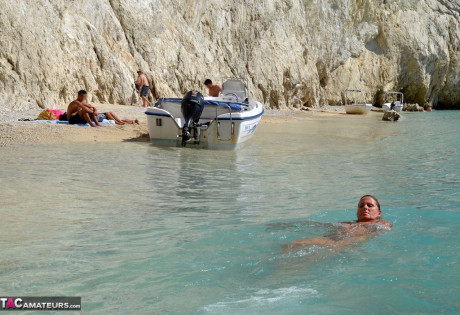 Hugely busty mature lady Chrissy swims and lounges at the beach stark naked - #182321