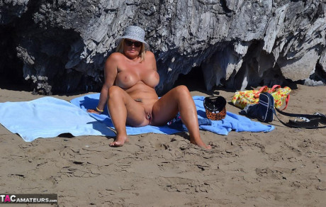 Hugely busty mature lady Chrissy swims and lounges at the beach stark naked - #182331