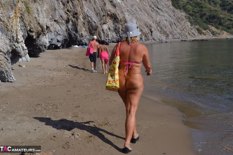 Hugely busty mature lady Chrissy swims and lounges at the beach stark naked - #182336