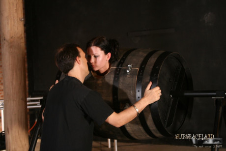 Lovely brunette in a bondage box Goldie giving head to a brutal BDSM handler