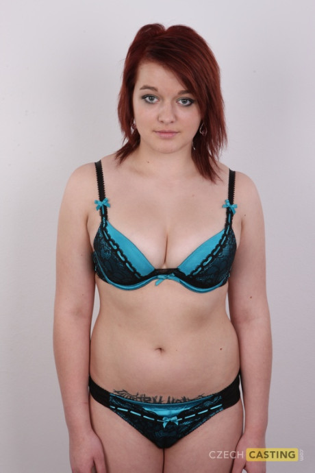 Redheaded amateur Tereza exposes a tattoo above her pussy while getting naked - #92286