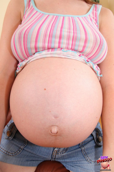Pregnant amateur strips to her socks on a couch in a confident manner - #118235