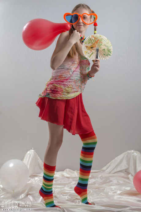 Thin young lady gf chick in pigtails and multi-colored socks takes off her clothes