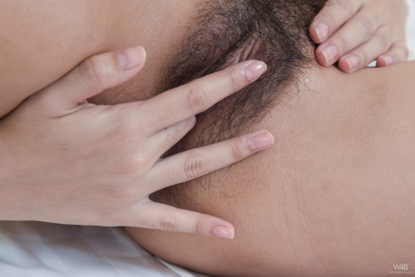 Oriental honey with hot humongous breasts Kahlisa fingers her furry beaver on a bed - #188071