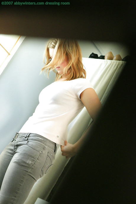 A secret camera captures a young teenie blonde pulling on pink panties over behind - #194824