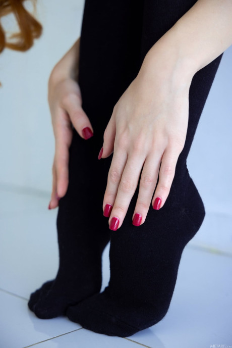 Natural red hair gets naked on a bed while sporting ebony over the knee socks - #316142