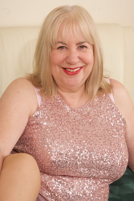 Old blondy Speedy Bee finger spreads her snatch on a bed in tan nylons - #269847