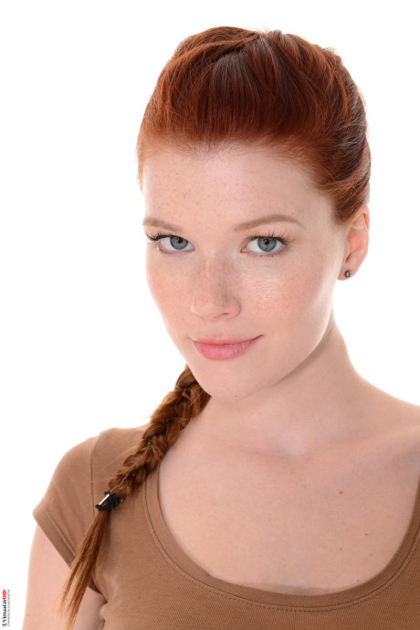 Attractive ginger head Mia Sollis does a slow striptease before crossing her long legs