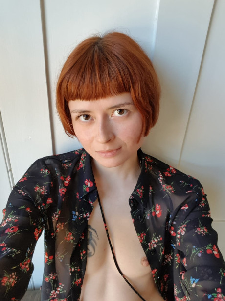 Skinny ginger head Enne toys her silky snatch while nude by a window in a solo - #324473