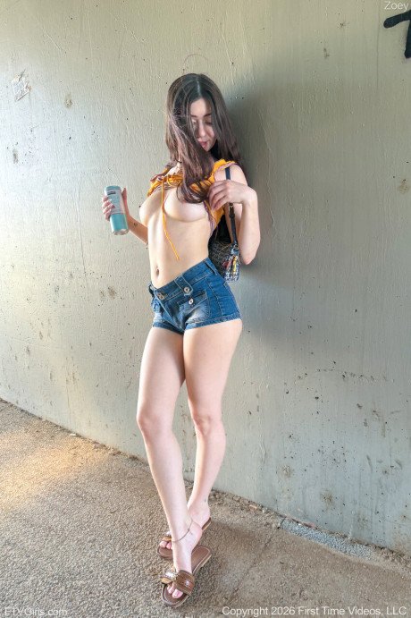 Sweet babe Zoey uncovers her tits while teasing in butt shorts outdoors - #302504