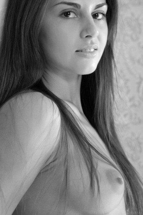 Breathtaking young Astrud A poses half undressed in a seat & shows her pretty body